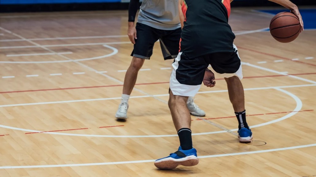 The loud squeaks of basketball shoes develop as parts of the sole slip on the court surface. Those slips repeat thousands of times a second. FreshSplash/Getty Images